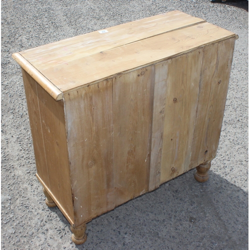 64 - An antique pine 3 drawer chest of drawers with turned wooden feet and handles, approx 88cm wide x 41... 