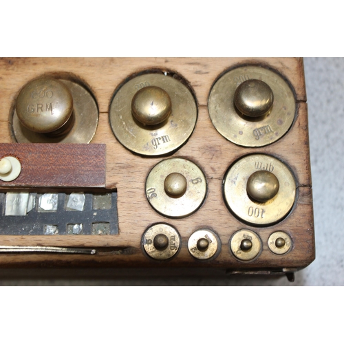 652 - Vintage set of brass and other balance scale weights, set in heavy wooden box, weights ranging from ... 