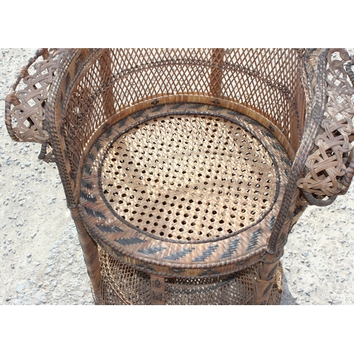 66 - A large vintage wicker peacock chair, approx 110cm wide x 53cm deep x 146cm tall