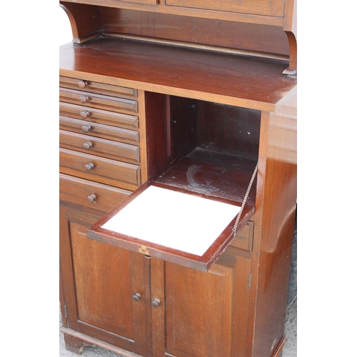 67 - An antique early 20th century mahogany dentists cabinet of upright form, the top tier having a 2 gla... 