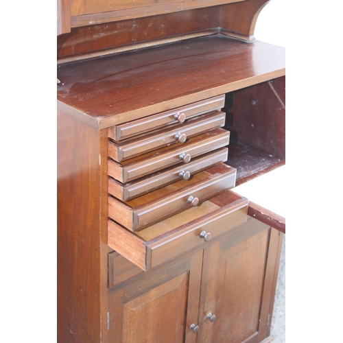 67 - An antique early 20th century mahogany dentists cabinet of upright form, the top tier having a 2 gla... 