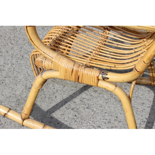 73 - In the manner of Franco Albini, a retro bamboo rocking chair, approx 57cm wide x 83cm deep x 115cm t... 