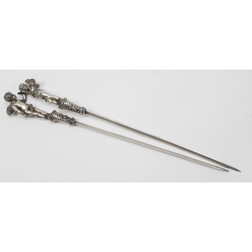 1026 - A pair of antique silver plated letter openers, the terminals formed as Putti or Cherubs, seemingly ... 