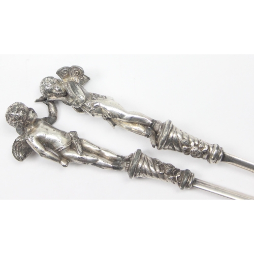 1026 - A pair of antique silver plated letter openers, the terminals formed as Putti or Cherubs, seemingly ... 