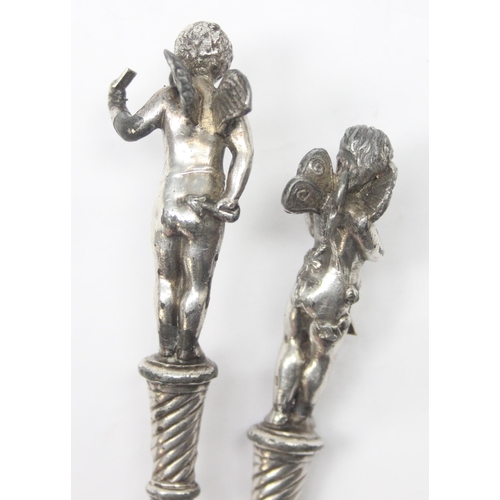 1026 - A pair of antique silver plated letter openers, the terminals formed as Putti or Cherubs, seemingly ... 