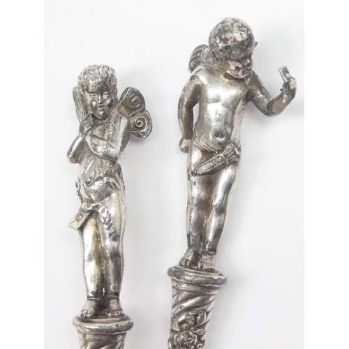 1026 - A pair of antique silver plated letter openers, the terminals formed as Putti or Cherubs, seemingly ... 