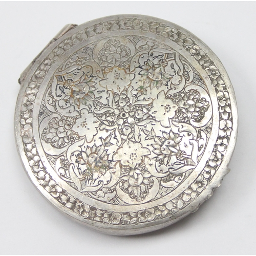 1028 - A vintage Middle Eastern or Asian silver pill box with intricate engraved decoration, seemingly unma... 