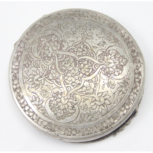 1028 - A vintage Middle Eastern or Asian silver pill box with intricate engraved decoration, seemingly unma... 