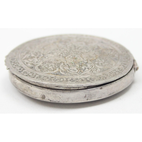 1028 - A vintage Middle Eastern or Asian silver pill box with intricate engraved decoration, seemingly unma... 