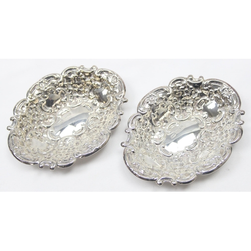 1030 - A pair of heavy gauge antique style embossed silver pin dishes, London 1971 by Richards & Knight, ea... 