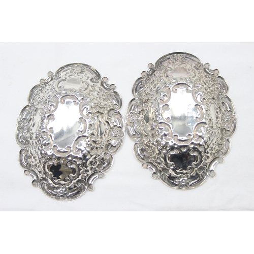 1030 - A pair of heavy gauge antique style embossed silver pin dishes, London 1971 by Richards & Knight, ea... 