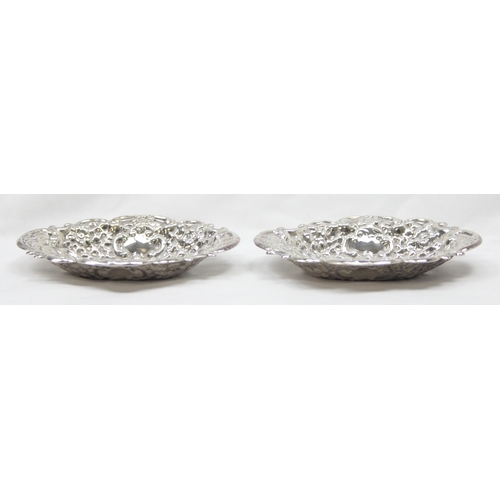 1030 - A pair of heavy gauge antique style embossed silver pin dishes, London 1971 by Richards & Knight, ea... 