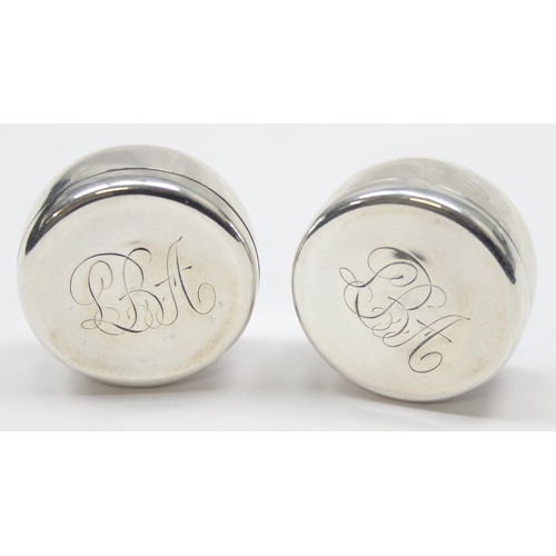 1038 - A pair of sterling silver pill boxes, possibly Danish but indistinctly marked, each with gilded inte... 