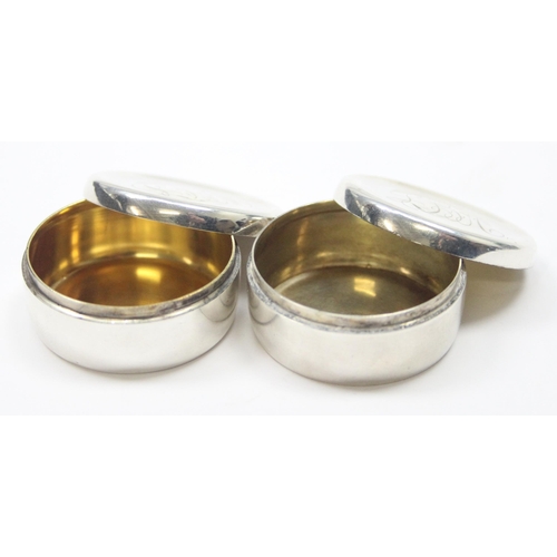 1038 - A pair of sterling silver pill boxes, possibly Danish but indistinctly marked, each with gilded inte... 