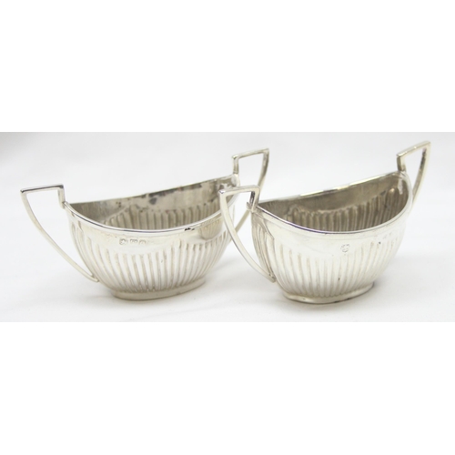 1041 - A pair of Victorian silver salts of canoe shape and gadrooned design, Chester 1899 & Birmingham 1898... 