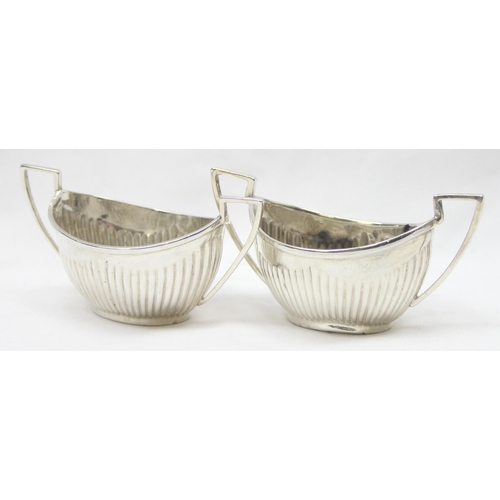 1041 - A pair of Victorian silver salts of canoe shape and gadrooned design, Chester 1899 & Birmingham 1898... 