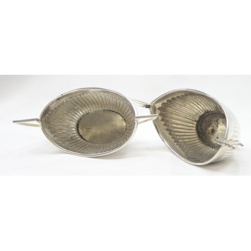 1041 - A pair of Victorian silver salts of canoe shape and gadrooned design, Chester 1899 & Birmingham 1898... 