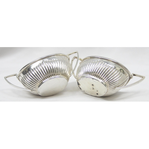 1041 - A pair of Victorian silver salts of canoe shape and gadrooned design, Chester 1899 & Birmingham 1898... 