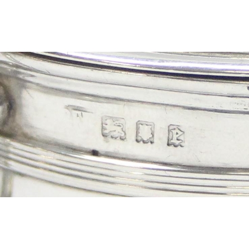 1044 - A large silver mustard pot of Georgian form, London 1920, makers mark rubbed, approx 10cm tall, appr... 