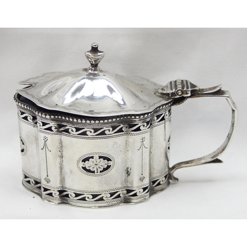 1061 - An early 20th century silver mustard pot of Georgian form with engraved and pierced decoration and b... 