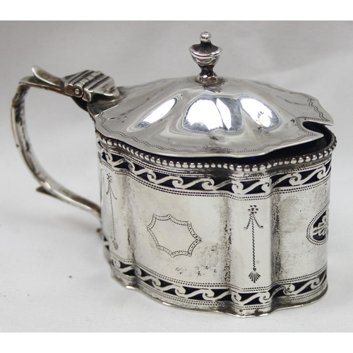 1061 - An early 20th century silver mustard pot of Georgian form with engraved and pierced decoration and b... 