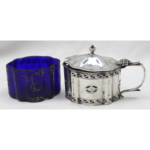 1061 - An early 20th century silver mustard pot of Georgian form with engraved and pierced decoration and b... 