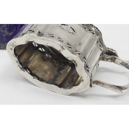 1061 - An early 20th century silver mustard pot of Georgian form with engraved and pierced decoration and b... 