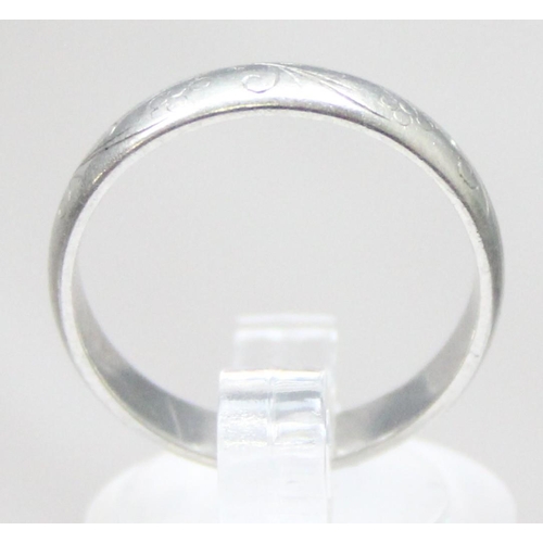 1101 - A vintage platinum band ring with engraved decoration, full hallmarked for Sheffield 1976 and XRF co... 