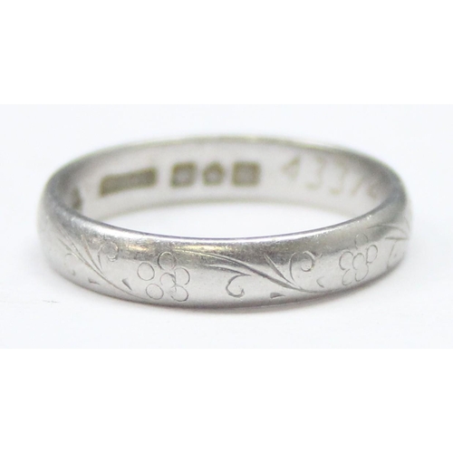 1101 - A vintage platinum band ring with engraved decoration, full hallmarked for Sheffield 1976 and XRF co... 