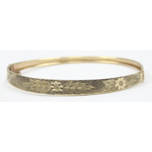 1116 - A retro 9ct gold cuff bangle with engraved decoration, marked 375 and XRF confirmed, approx 5.57g gr... 