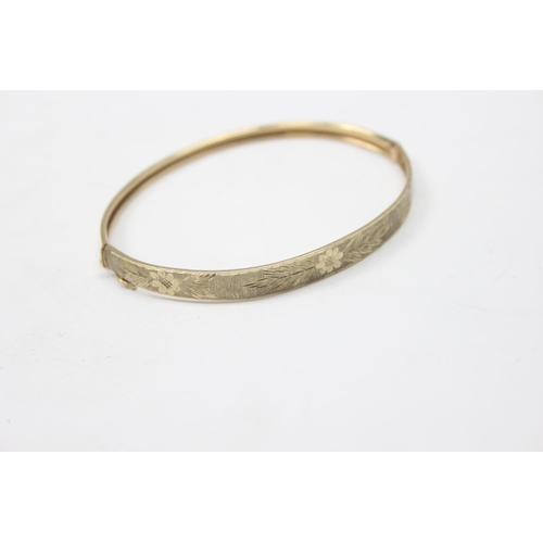 1116 - A retro 9ct gold cuff bangle with engraved decoration, marked 375 and XRF confirmed, approx 5.57g gr... 