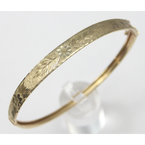 1116 - A retro 9ct gold cuff bangle with engraved decoration, marked 375 and XRF confirmed, approx 5.57g gr... 