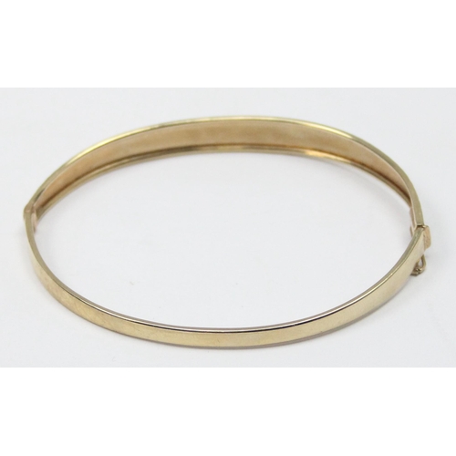 1116 - A retro 9ct gold cuff bangle with engraved decoration, marked 375 and XRF confirmed, approx 5.57g gr... 