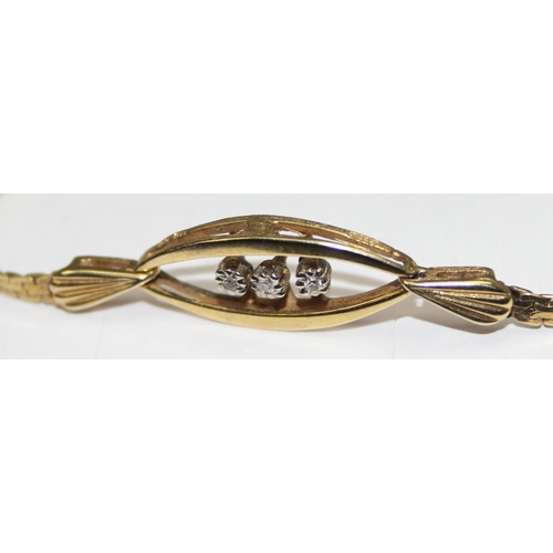 1117 - A retro West German made 9ct gold and diamond set bracelet, a trio of small diamonds flanked by 2 le... 