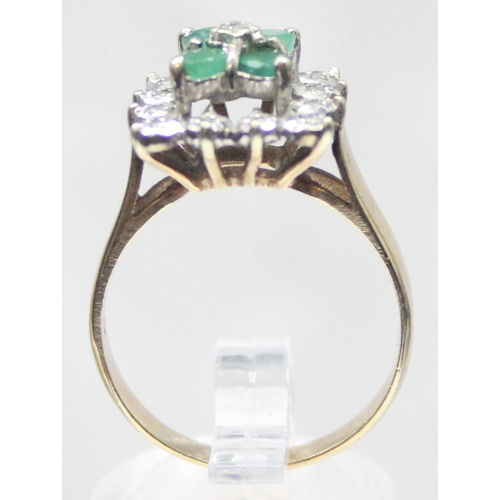 1118 - A diamond and emerald set cocktail ring of retro style, 4 square set emeralds with a small central d... 