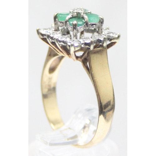 1118 - A diamond and emerald set cocktail ring of retro style, 4 square set emeralds with a small central d... 