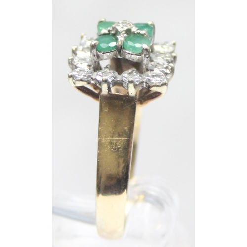 1118 - A diamond and emerald set cocktail ring of retro style, 4 square set emeralds with a small central d... 