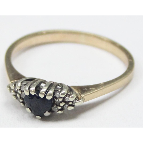 1132 - 9ct gold diamond and sapphire set ring, marked for London 1987, approx size R, approx 2.34g gross