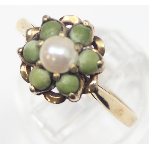 1134 - An unusual 9ct gold floral cluster ring set with a central pearl surrounded by 6 matte green stone b... 