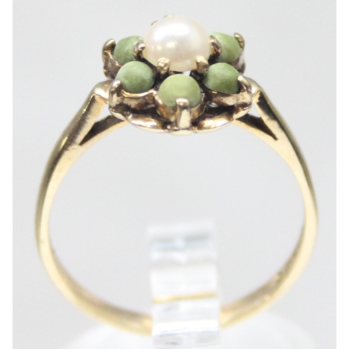 1134 - An unusual 9ct gold floral cluster ring set with a central pearl surrounded by 6 matte green stone b... 