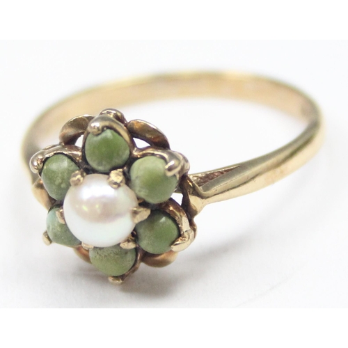 1134 - An unusual 9ct gold floral cluster ring set with a central pearl surrounded by 6 matte green stone b... 