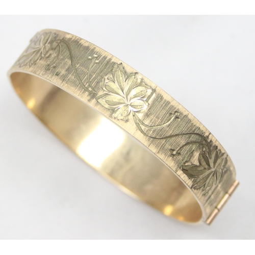 1139 - A retro 9ct rolled gold 50 micron bangle with engraved decoration, approx 59mm x 55mm interior measu... 