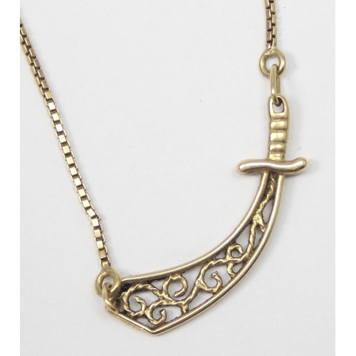 1143 - An unusual 18ct gold pendant necklace set with a filigree pendant formed as a scimitar sword on fine... 