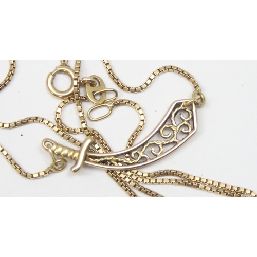 1143 - An unusual 18ct gold pendant necklace set with a filigree pendant formed as a scimitar sword on fine... 