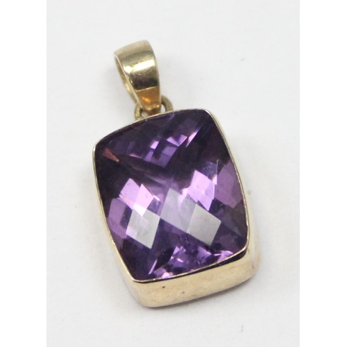 1169 - A 9ct gold mounted pendant with facet cut purple stone, marked and XRF confirmed, approx 1.56g gross