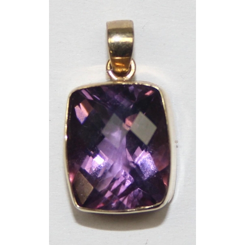 1169 - A 9ct gold mounted pendant with facet cut purple stone, marked and XRF confirmed, approx 1.56g gross