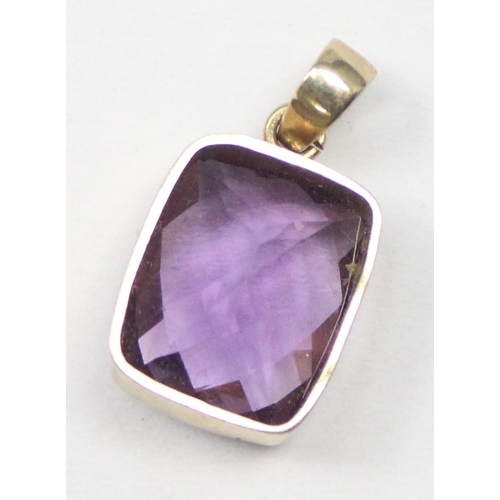 1169 - A 9ct gold mounted pendant with facet cut purple stone, marked and XRF confirmed, approx 1.56g gross