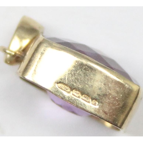 1169 - A 9ct gold mounted pendant with facet cut purple stone, marked and XRF confirmed, approx 1.56g gross