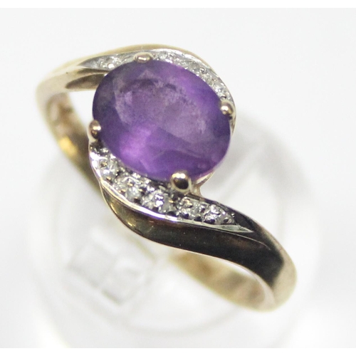 1170 - A vintage 9ct gold diamond and amethyst ring in crossover setting, marked and XRF confirmed, approx ... 