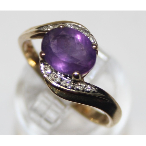 1170 - A vintage 9ct gold diamond and amethyst ring in crossover setting, marked and XRF confirmed, approx ... 